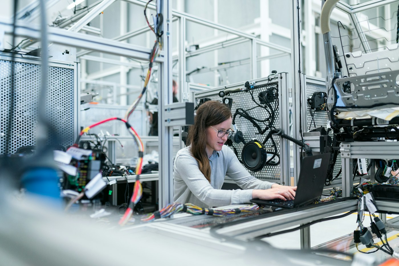 Engineer working at a computer among technical equipment in a modern lab